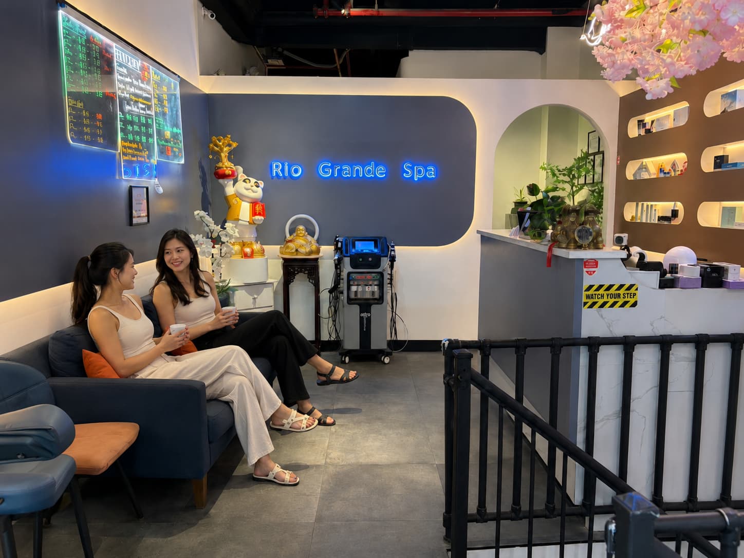 Spa lounge and waiting area with neon service menu boards at Rio Grande Spa in Lower Manhattan